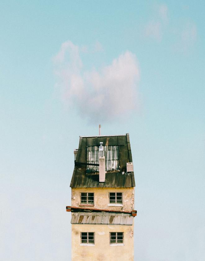 a photo of a yellow house against a blue sky
